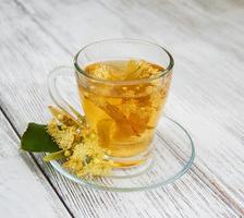 cup of herbal tea with linden flowers photo