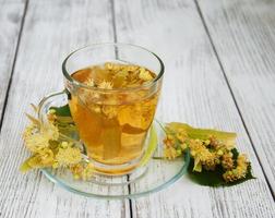 cup of herbal tea with linden flowers photo