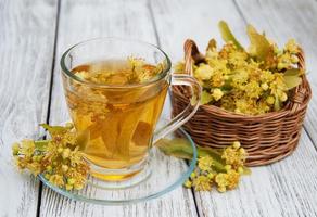 cup of herbal tea with linden flowers photo