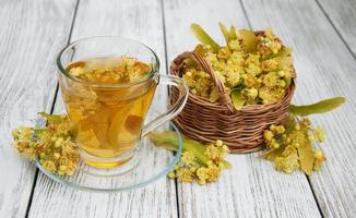 cup of herbal tea with linden flowers photo