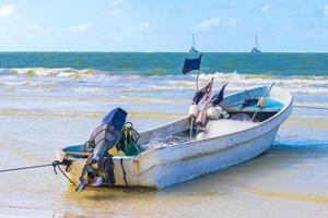 Beautiful Holbox island beach with boat and turquoise water Mexico. photo