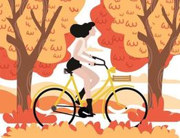 mujer de otoño montando una bicicleta con fondo de árbol vector