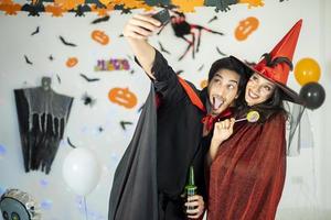 happy couple of love  in costumes and makeup on a celebration of Halloween photo