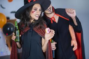 happy couple of love  in costumes and makeup on a celebration of Halloween photo