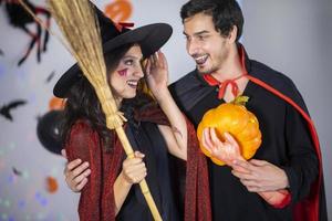 happy couple of love  in costumes and makeup on a celebration of Halloween photo