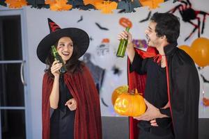 happy couple of love  in costumes and makeup on a celebration of Halloween photo