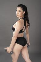 Beautiful fitness body builder woman in Studio photo