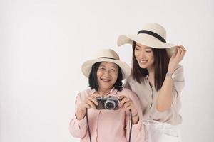 Asian older woman and her daughter on white background, Travel concept photo