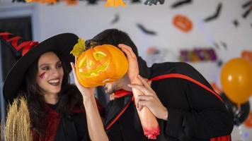 happy couple of love  in costumes and makeup on a celebration of Halloween photo