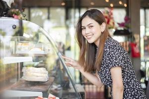 Beautiful woman in bakery shop photo