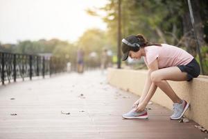 Beautiful woman is listening music and exercise  in the park
