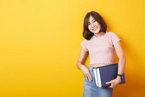 Beautiful asian woman University student happy on yellow background photo