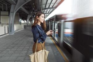 Beautiful business woman in metro train in city photo