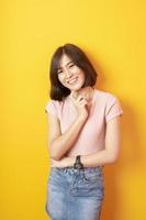 Beautiful asian woman University student happy on yellow background photo