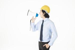 Young engineering man is announcing with megaphone photo