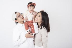 Happy Asian family on white background photo