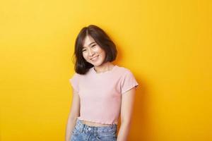 Beautiful asian woman University student happy on yellow background photo