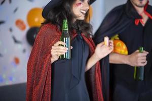 happy couple of love  in costumes and makeup on a celebration of Halloween photo