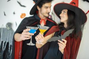 happy couple of love  in costumes and makeup on a celebration of Halloween photo