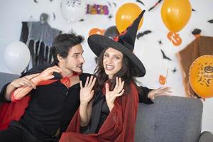 happy couple of love  in costumes and makeup on a celebration of Halloween photo