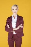 Portrait of confidence caucasian business woman on yellow background