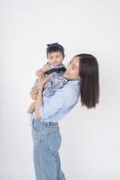 Asian mother and adorable baby girl are  happy on white background photo