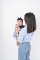 Asian mother and adorable baby girl are  happy on white background photo