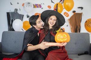 happy couple of love  in costumes and makeup on a celebration of Halloween photo