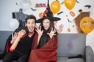 happy couple of love  in costumes and makeup on a celebration of Halloween photo