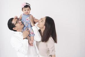 Happy Asian family on white background photo