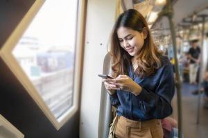 Beautiful business woman in metro train in city photo