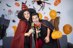 happy couple of love  in costumes and makeup on a celebration of Halloween photo