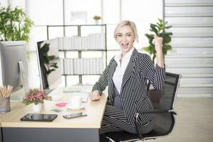 Beautiful Caucasian woman is success in her business plan photo