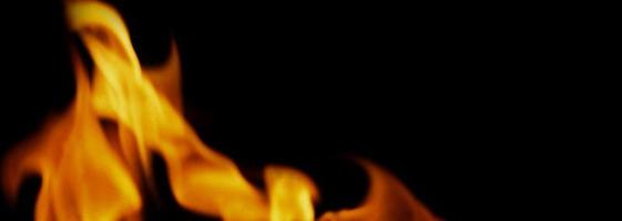 Fire background. Abstract burning flame and black background. photo