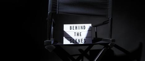 Director chair with behind the scene banner light box. photo