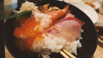 Close up images of japanese seafood rice bowl or kaisendon sashimi donburi. photo