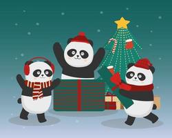 árbol de navidad de invierno y familia de animales panda decorando el árbol de navidad en la nieve. vector