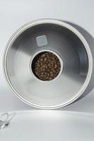 Large open jar of coffee beans on a white background. photo