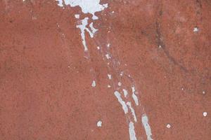 Texture of Wall stains after white rain. Background of wall stains. Stains on red wall. photo