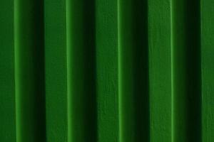 Green brick wall background.Grassy surface of colour building. photo