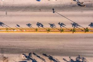 Aerial view of the street intersection with cars driving down the road. photo