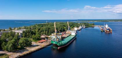 Riga, Latvia. June 10, 2021. Cargo ship at floating dry dock is being renovated photo