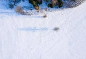 Beautiful aerial view of the huge frozen lake in the middle of a forest in Latvia. Frozen Ungurs lake in Latvia. photo