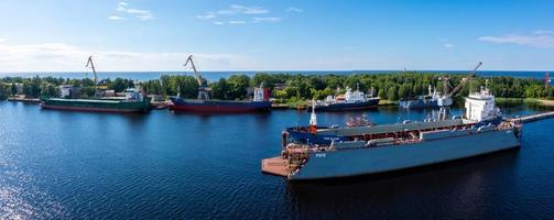 Riga, Latvia. June 10, 2021. Cargo ship at floating dry dock is being renovated
