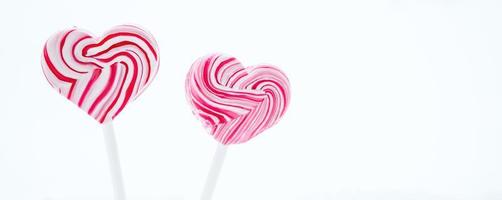 Two pink heart-shaped lollipop. photo