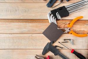 Set of work tools on a wooden background. photo