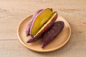 Grilled or baked Japanese sweet potatoes on wood plate photo