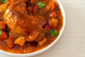 chicken stew with tomatoes, onions, carrot and potatoes photo