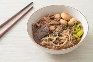 Thai noodle with pork, stewed pork, meatball and pork liver in blood soup photo