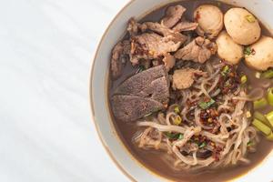 Thai noodle with pork, stewed pork, meatball and pork liver in blood soup photo